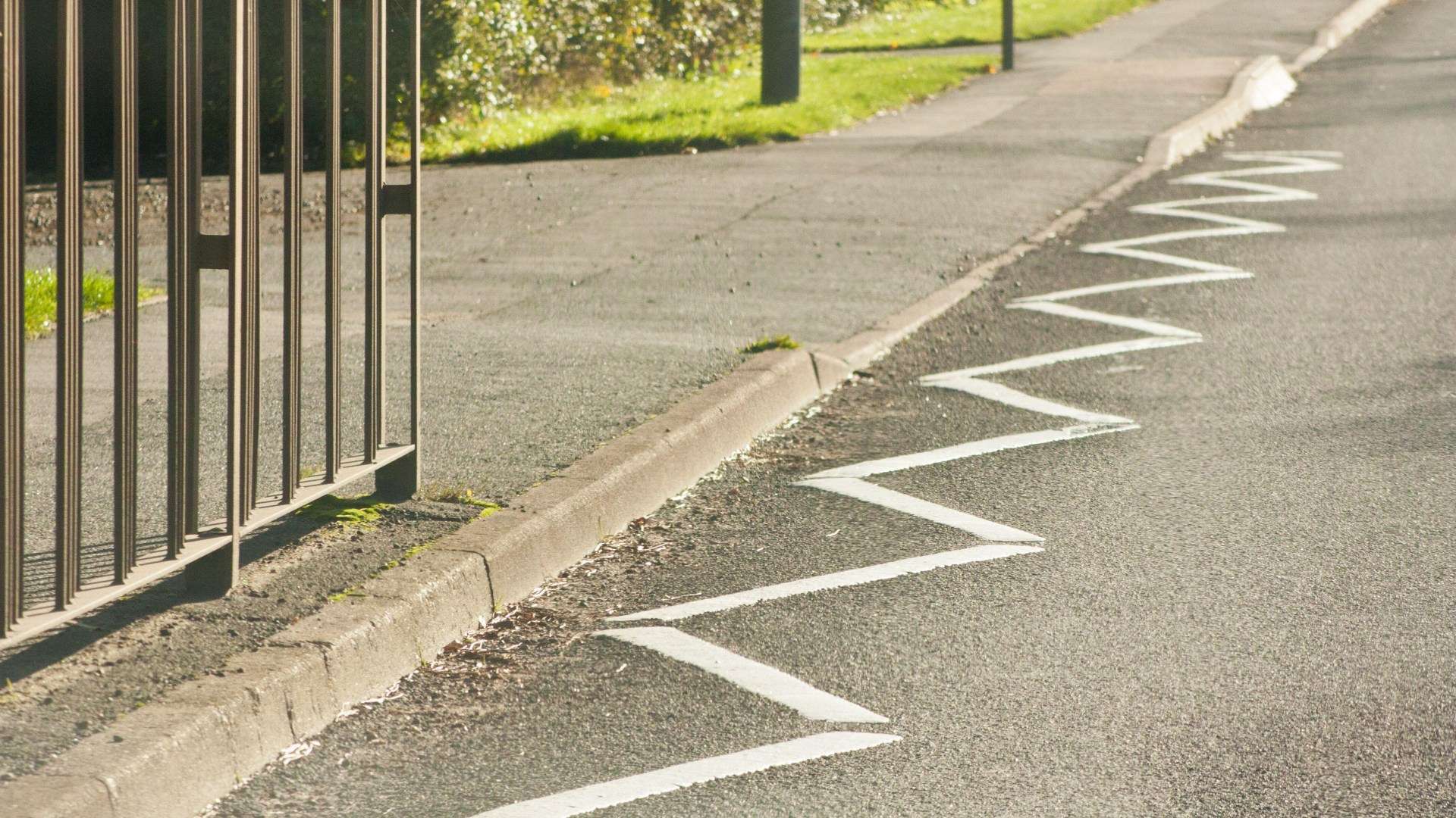 What do white zig-zag lines on the road mean and can I be fined for parking on them?